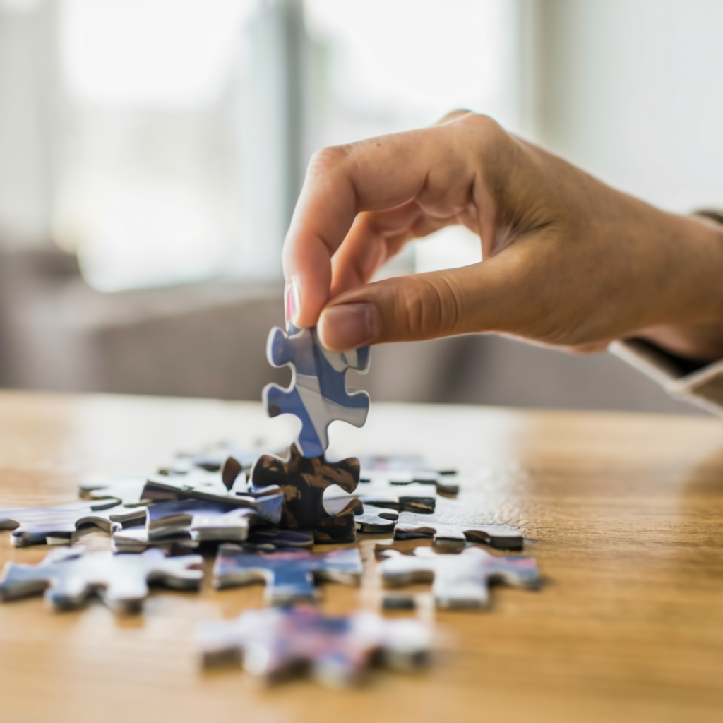 Close up of a hand putting together a puzzle