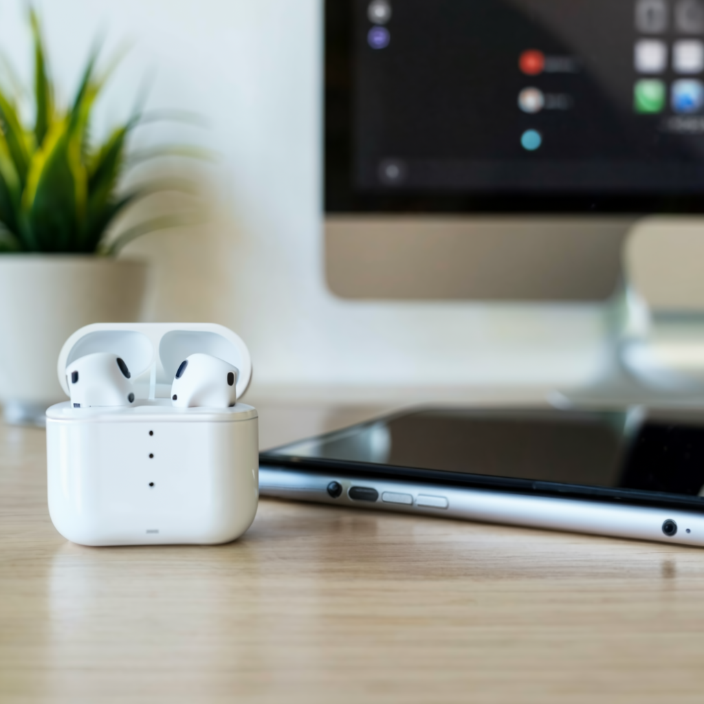 Close up of earpods on a desk next to a mobile phone